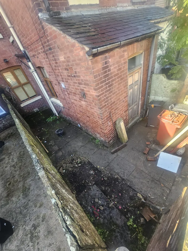 Bolton back yard and outbuilding before paving