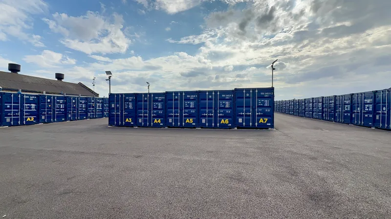 Storage units in Wallasey: a row of brand-new blue 20ft storage containers in the yard at Just Contain It, Corporation Road, Birkenhead