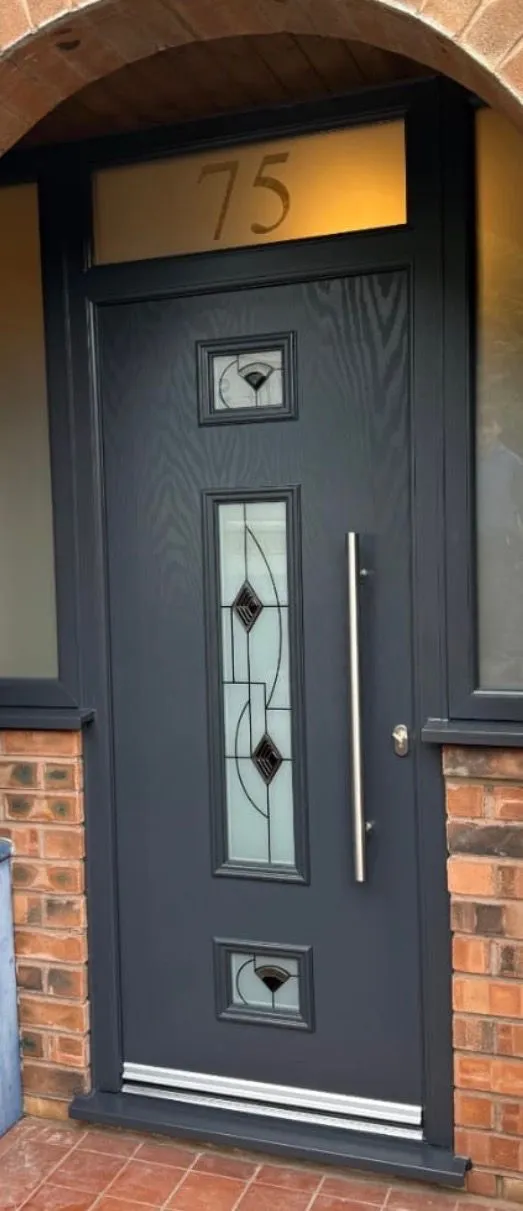 White composite door with decorative frosted glass panels fitted to a brick home.
