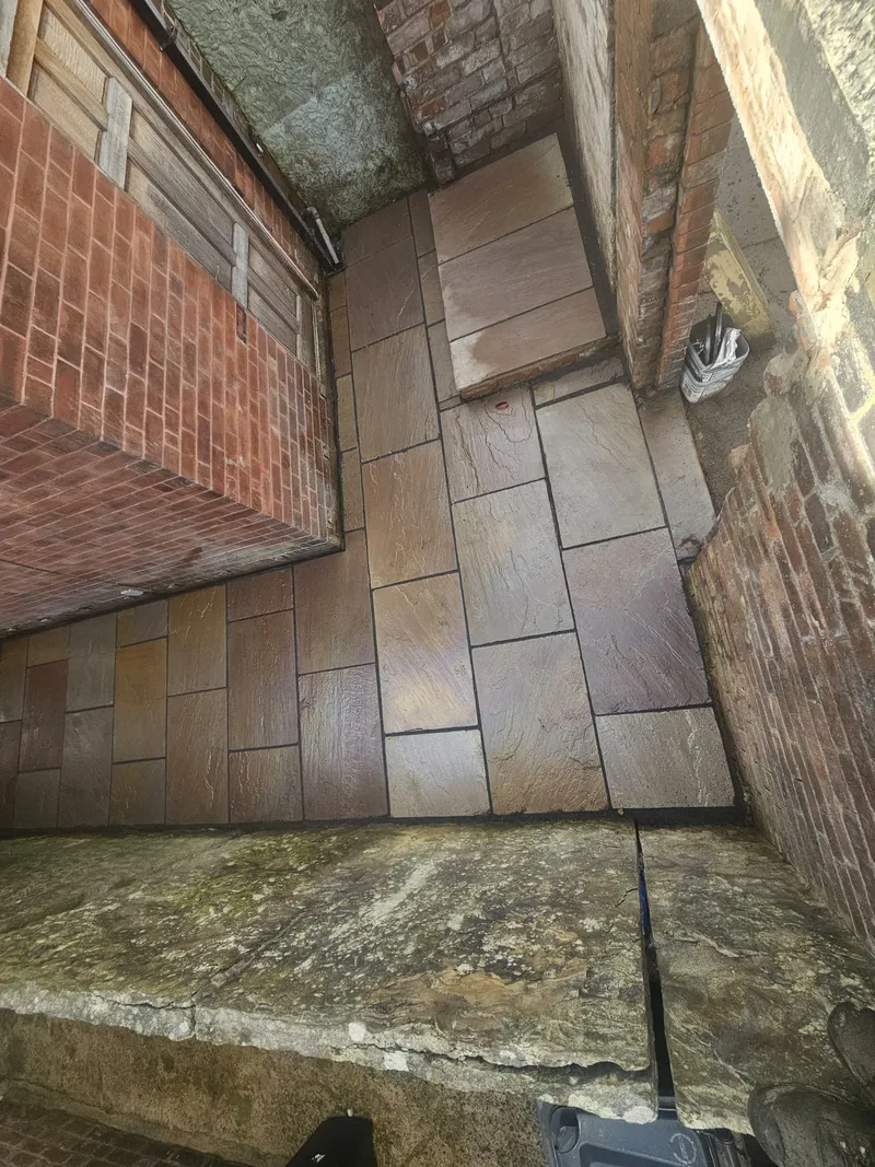 Indian sandstone paving laid around the yard corner