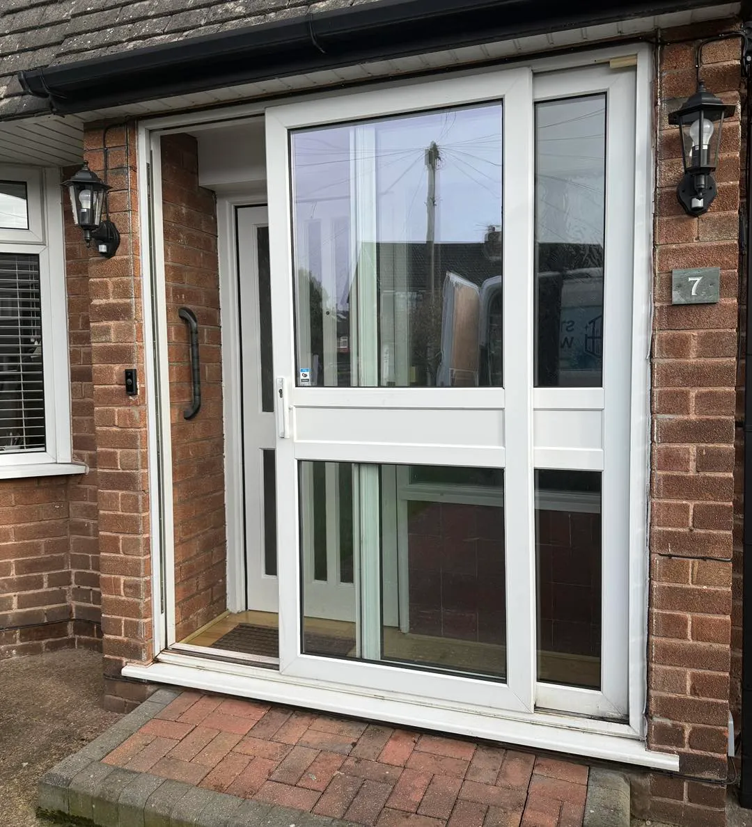 Double glazed doors installation — uPVC French doors fitted to a red brick home in Greater Manchester.