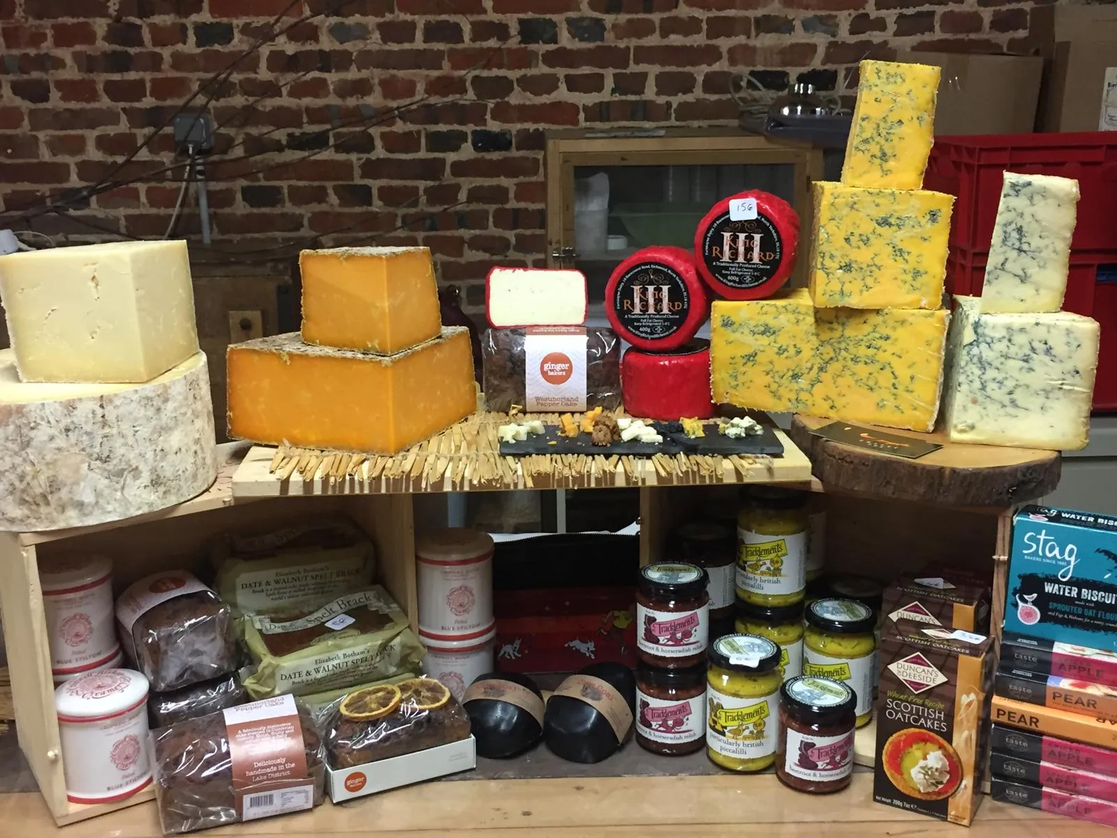 Showcasing British cheese at a French farmers market with various artisanal cheeses and traditional accompaniments