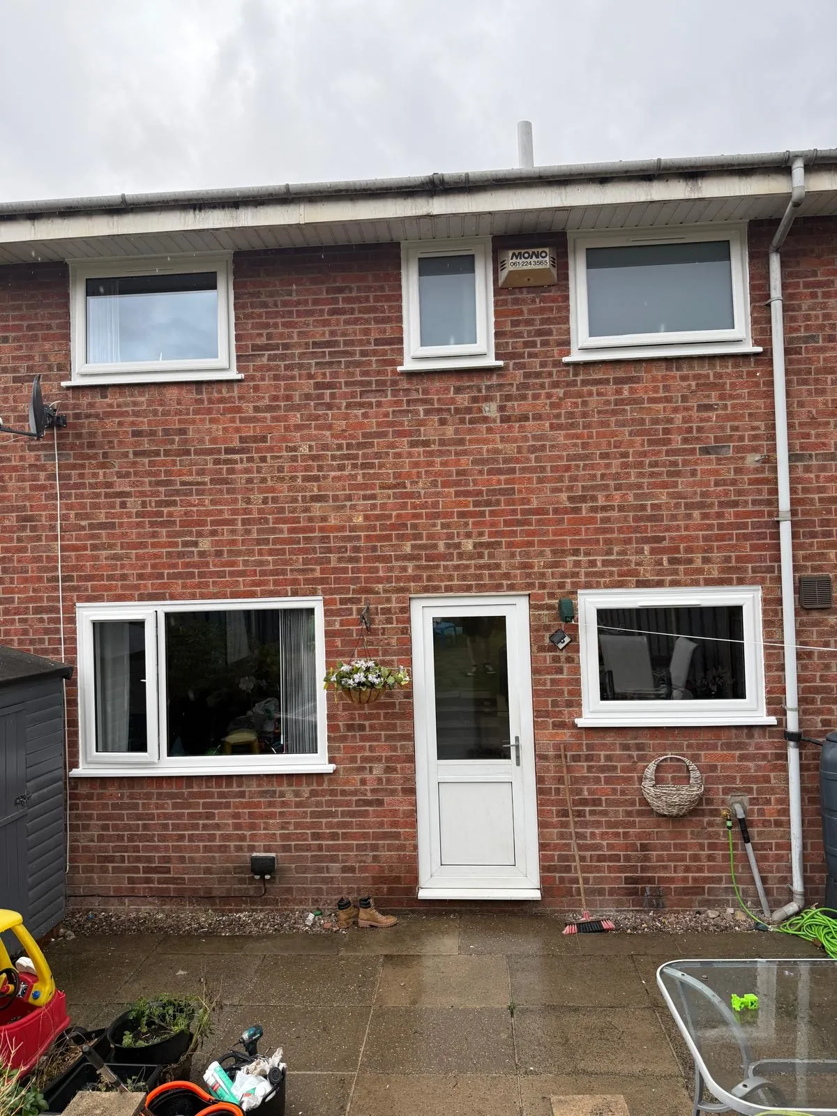 White uPVC back door and windows installed on a terraced house exterior.