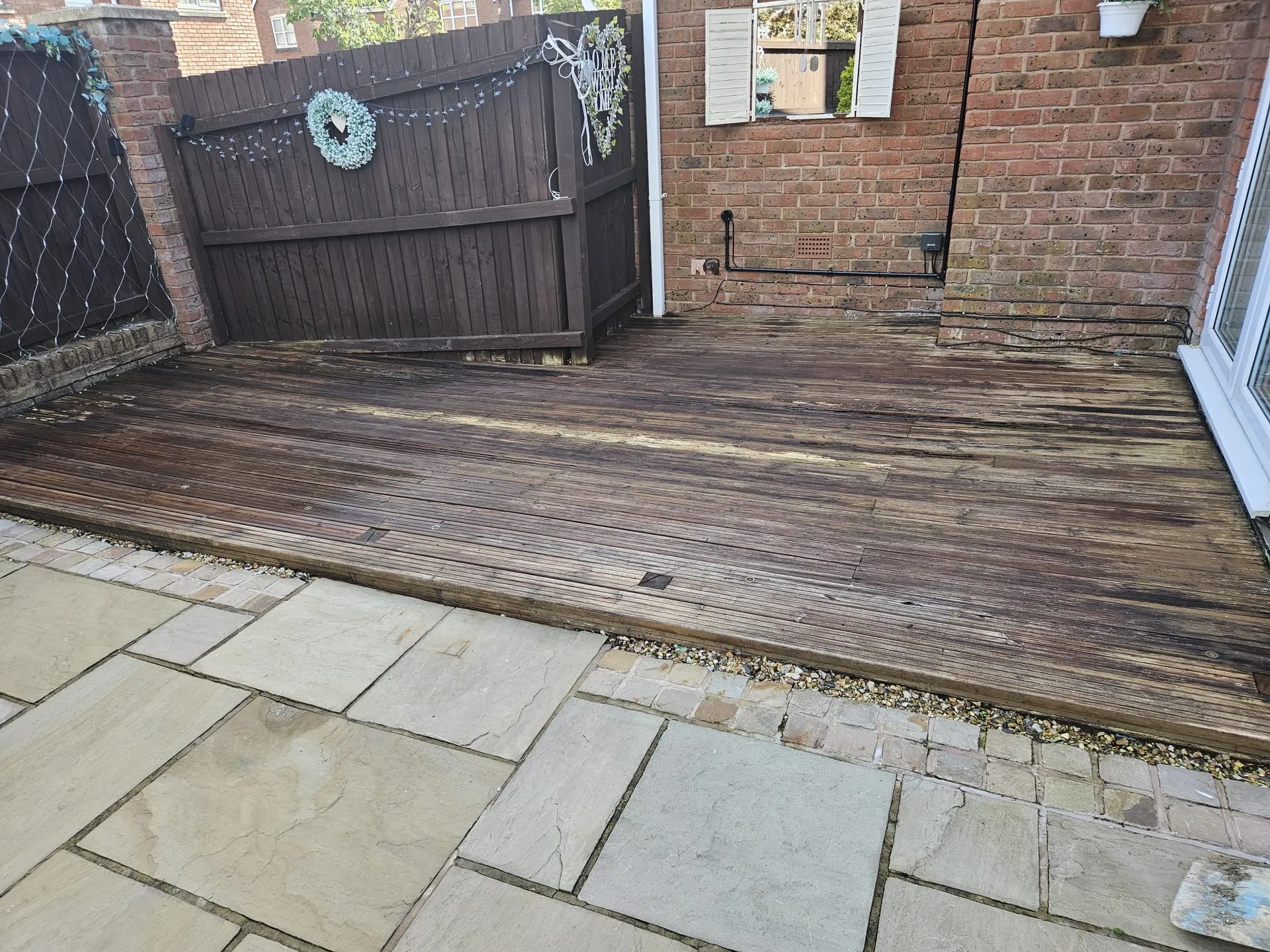 Old weathered timber decking before removal - Bolton