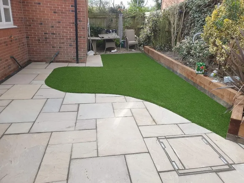 Modern artificial grass garden with paving