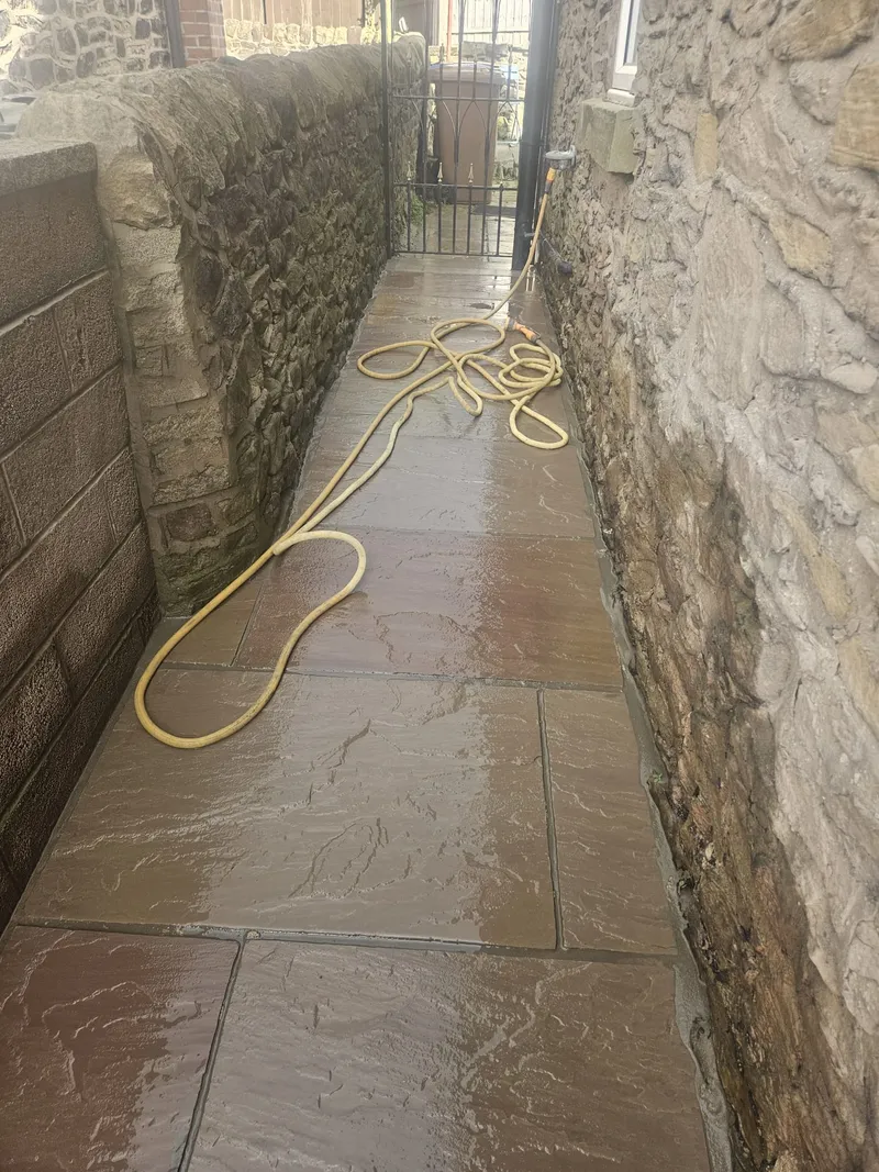 Indian sandstone side path between stone walls in Adlington