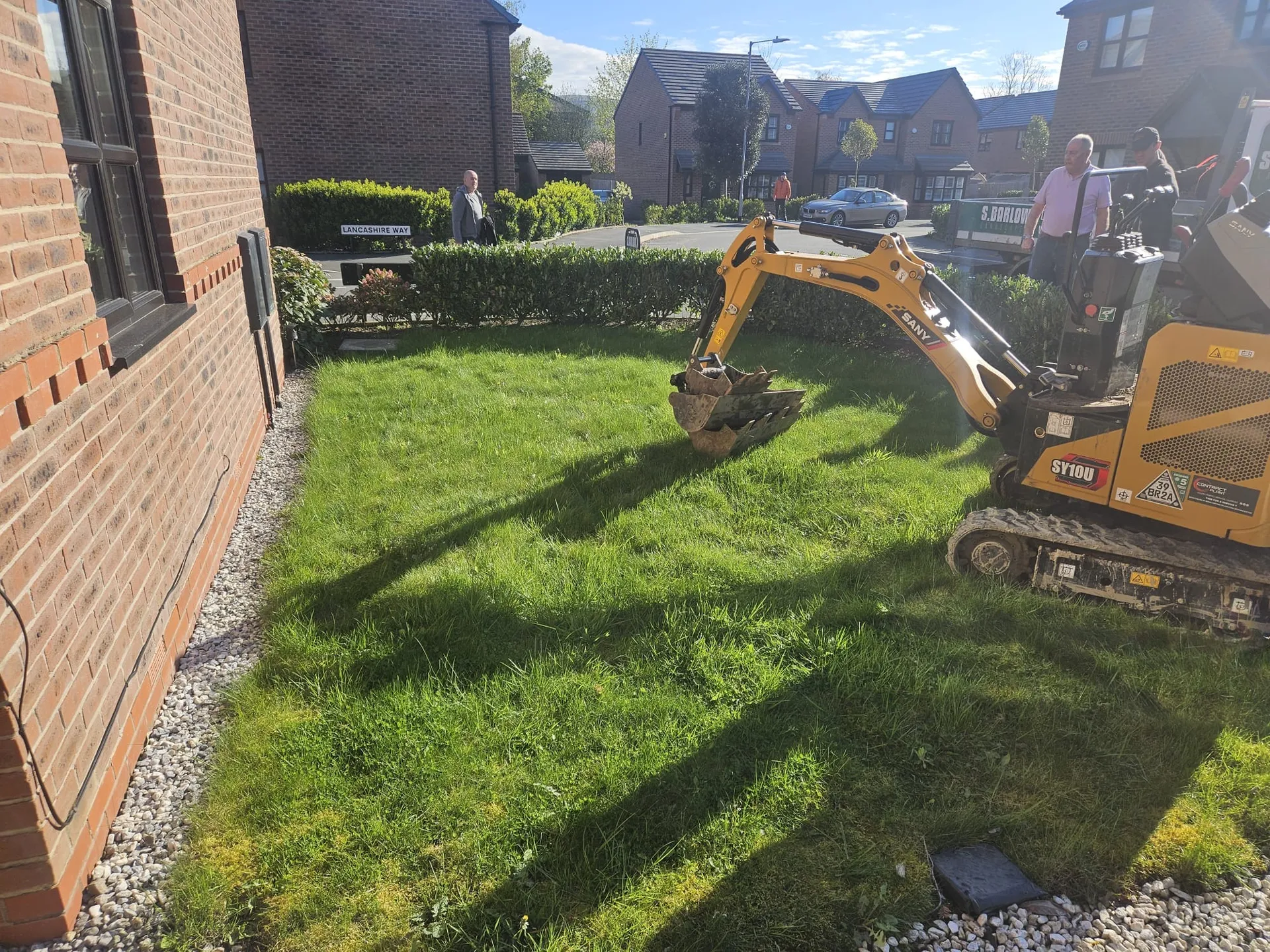 Construction work preparing ground for artificial grass installation