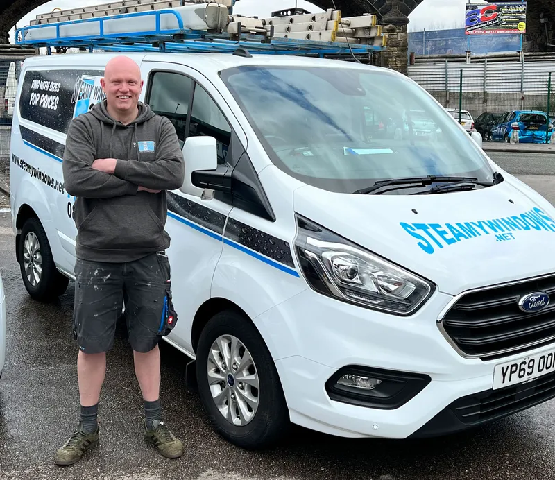 Steamy Windows technician carrying out broken window glass repair in Bolton