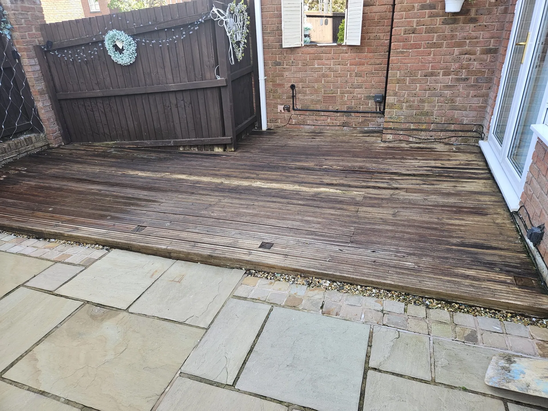 Worn timber decking boards before composite replacement